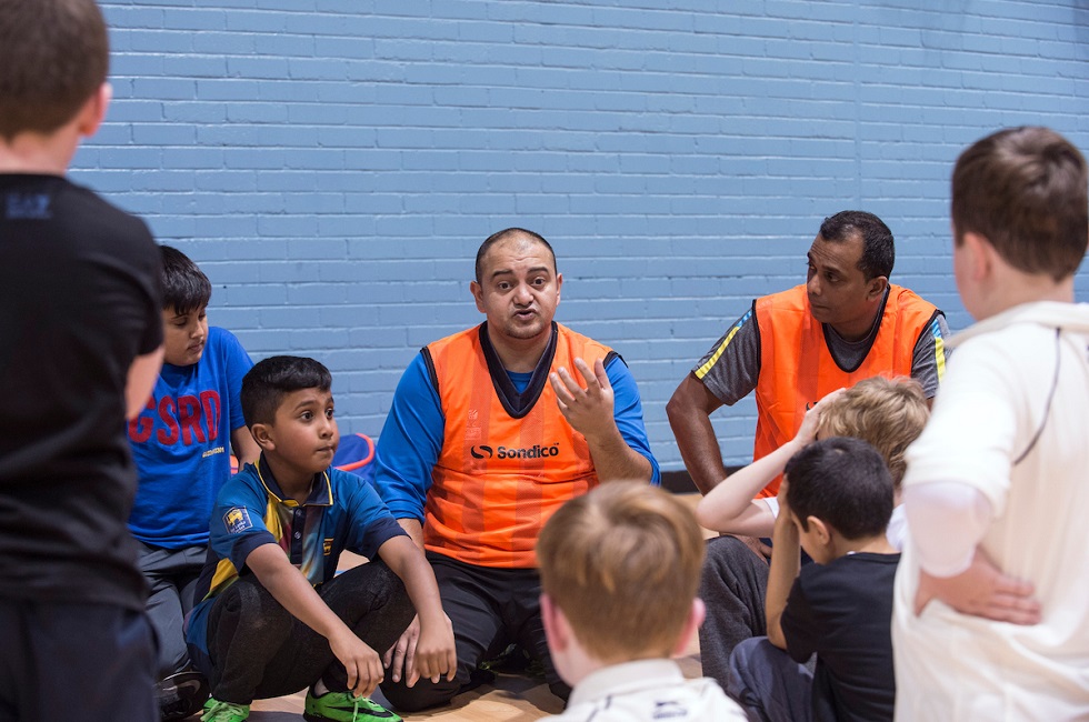 Ammar Ashraf coaches kids during cricket session