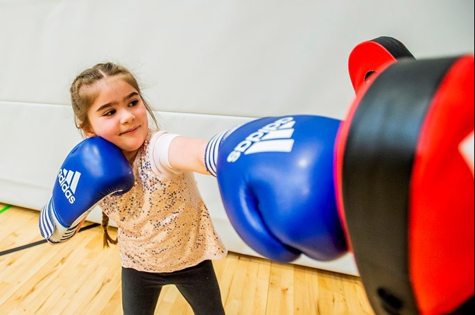 A youngster enjoys trying boxing