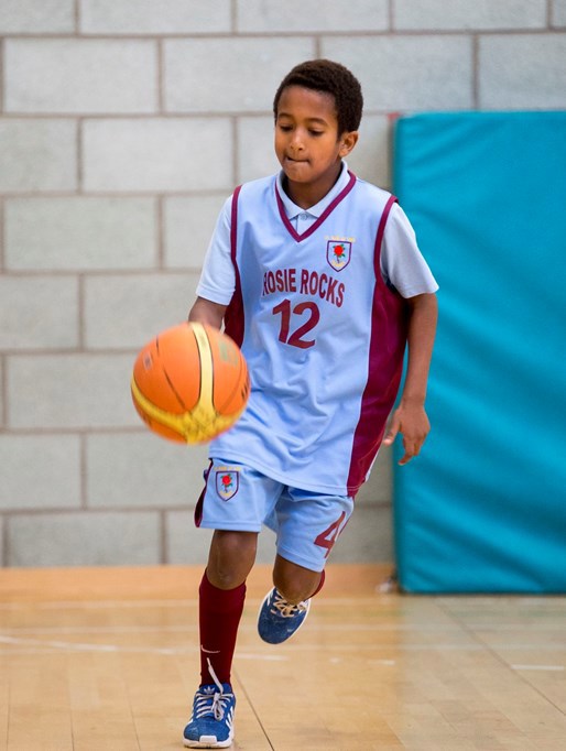 A youngster enjoys basketball
