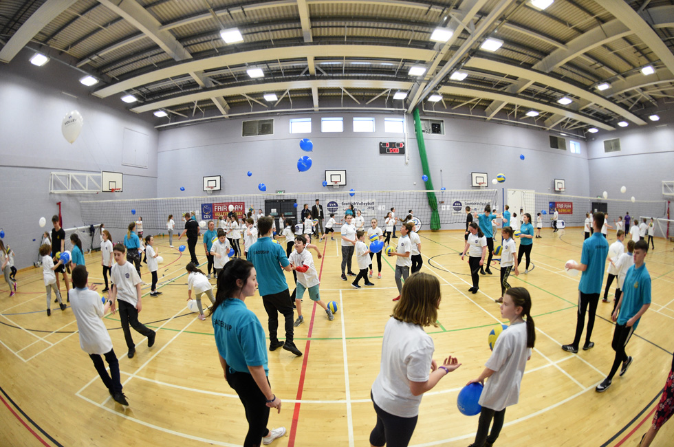 Gym Hall with people playing Volleyball