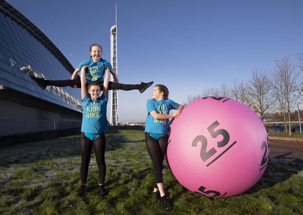 Posing alongside a giant pink number 25 National Lottery ball gymnasts Krystel Trainer, Madeline Kerr and Taylor McAllister from VIP Sports Academy in Motherwell 