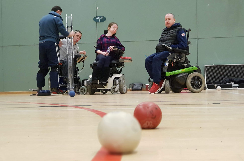 Wheelchair users playing boccia