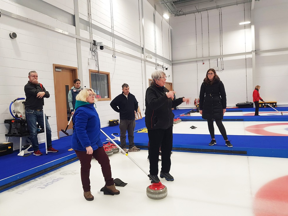 Sandra Black participates in a deaf-friendly curling session at the National Curling Academy