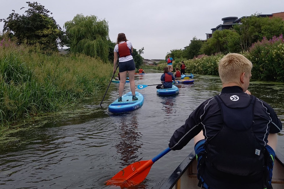 Young carers trying paddleboarding