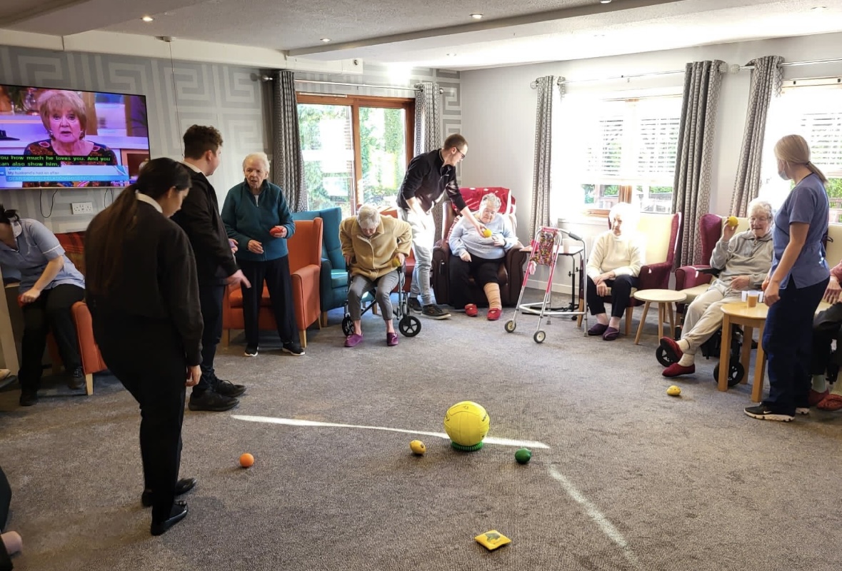 High school pupils leading a session at a care home