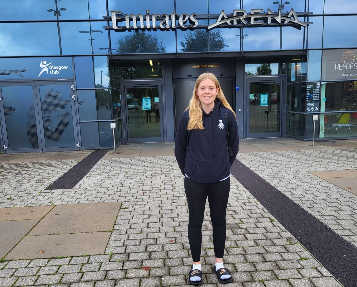 Erin stands outside Emirates Arena in Glasgow